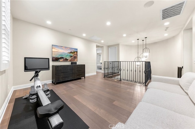 workout area featuring visible vents, recessed lighting, and wood finished floors