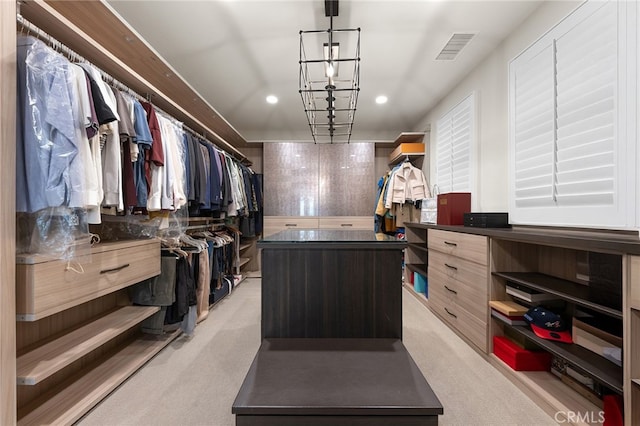 spacious closet featuring visible vents and light colored carpet