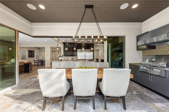 dining space featuring recessed lighting, wood ceiling, and stone finish flooring