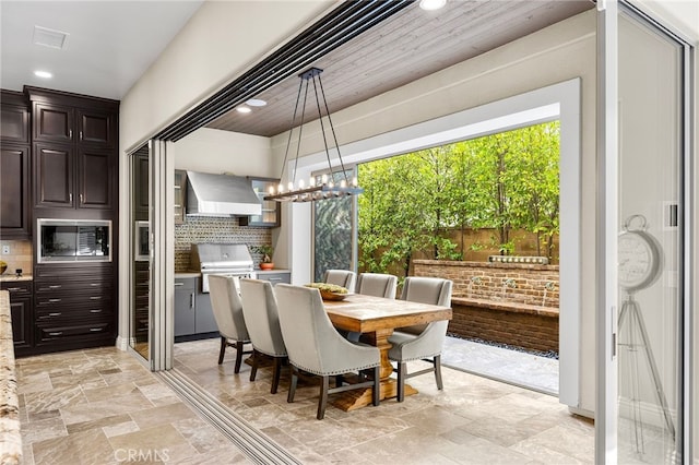 dining area with recessed lighting, a notable chandelier, stone finish floor, and visible vents