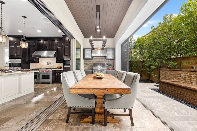 dining room featuring wooden ceiling, stone finish floor, and recessed lighting