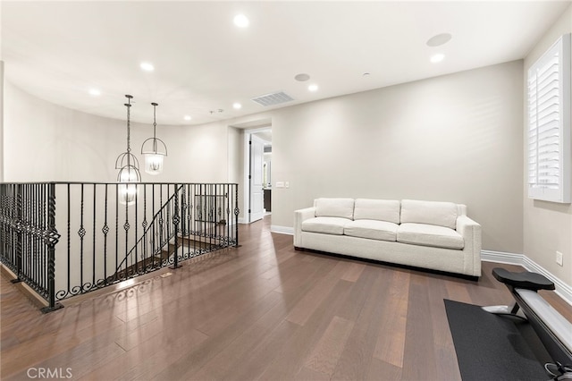 living room featuring a chandelier, visible vents, recessed lighting, and wood finished floors