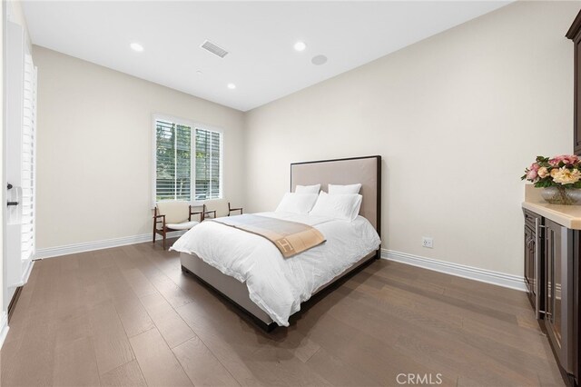 bedroom with visible vents, recessed lighting, dark wood-type flooring, and baseboards