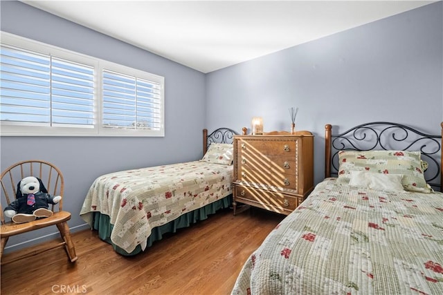 bedroom with wood finished floors