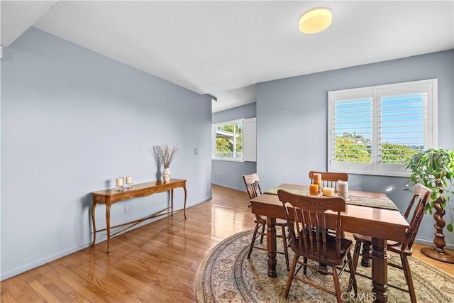 dining room featuring baseboards and light wood-style floors