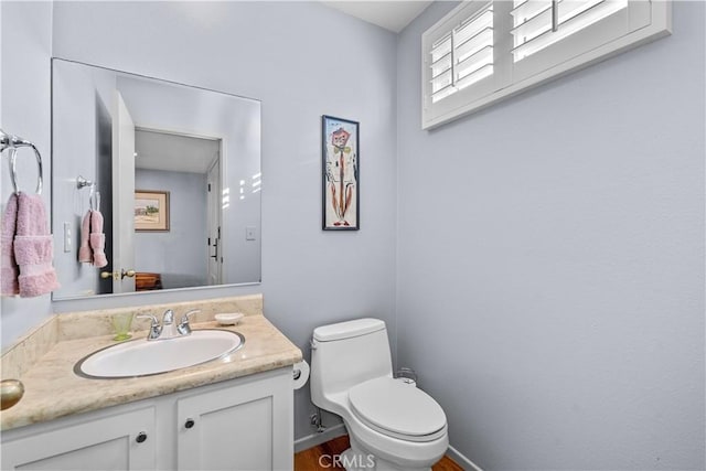 half bath featuring toilet and vanity