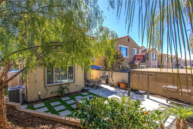 view of yard with a patio, cooling unit, and fence