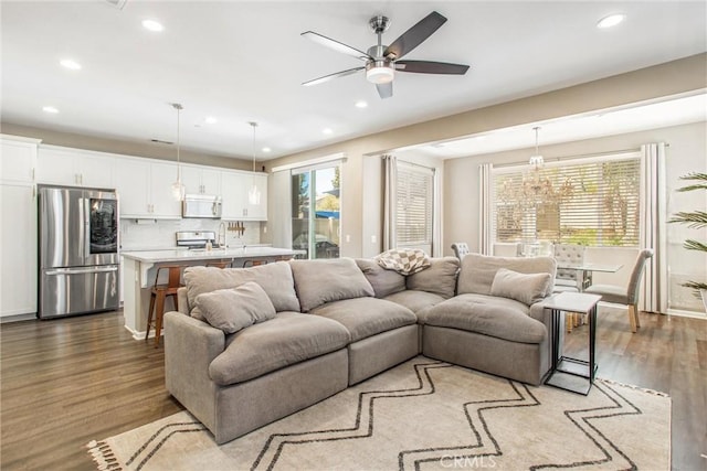 living area with recessed lighting, dark wood finished floors, and a ceiling fan