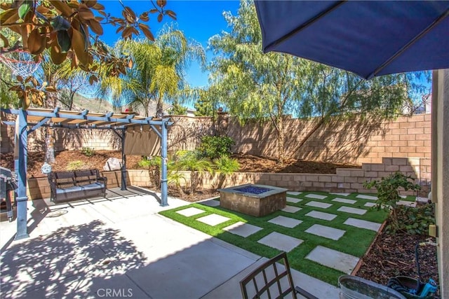 view of patio featuring a fire pit, a fenced backyard, and a pergola