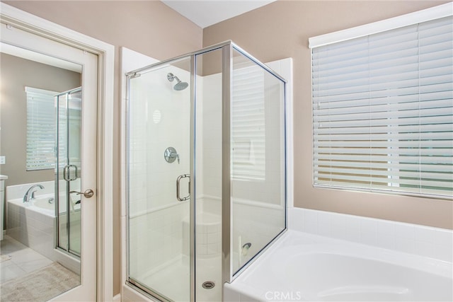 full bath with a garden tub and a stall shower