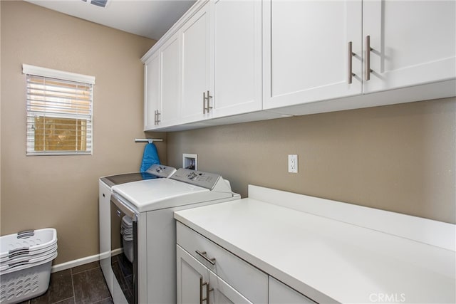 laundry room featuring cabinet space, washer and dryer, and baseboards