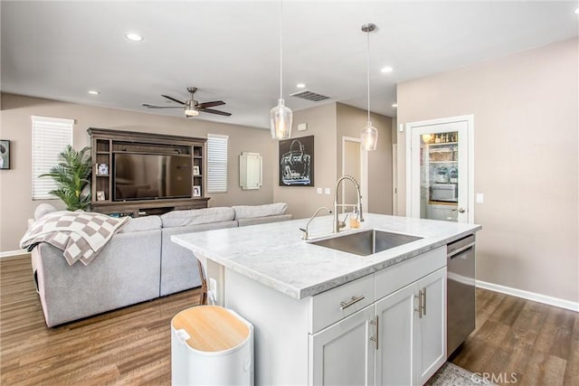 kitchen featuring visible vents, dark wood-type flooring, a sink, white cabinetry, and dishwasher