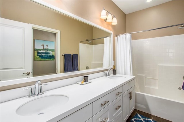 bathroom with a sink, shower / tub combo with curtain, and double vanity