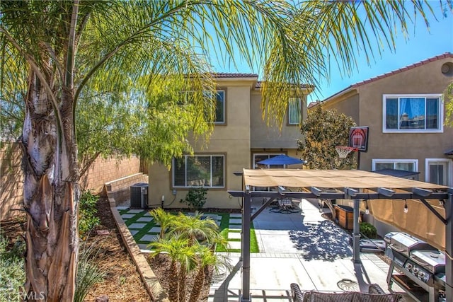 back of property with stucco siding, central air condition unit, outdoor dining space, fence, and a patio area