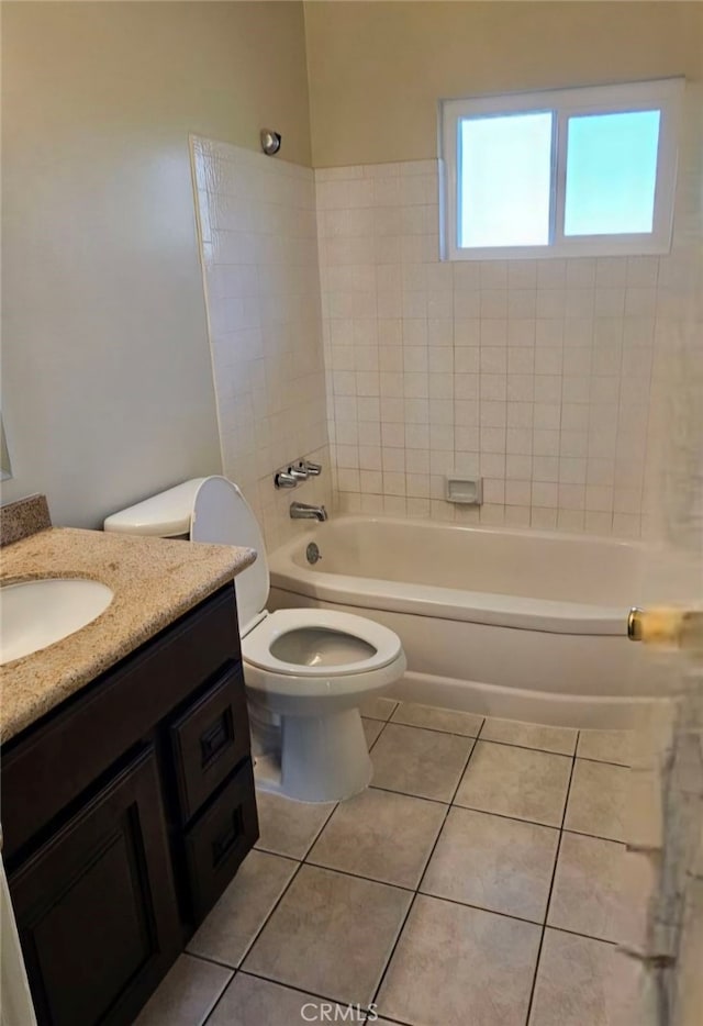 full bathroom with tile patterned floors, washtub / shower combination, toilet, and vanity