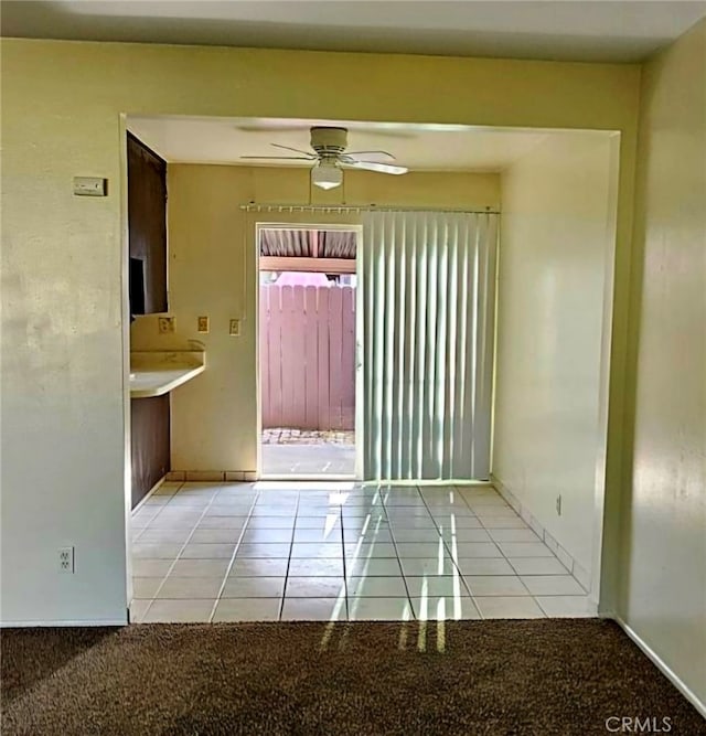 empty room with tile patterned floors and ceiling fan