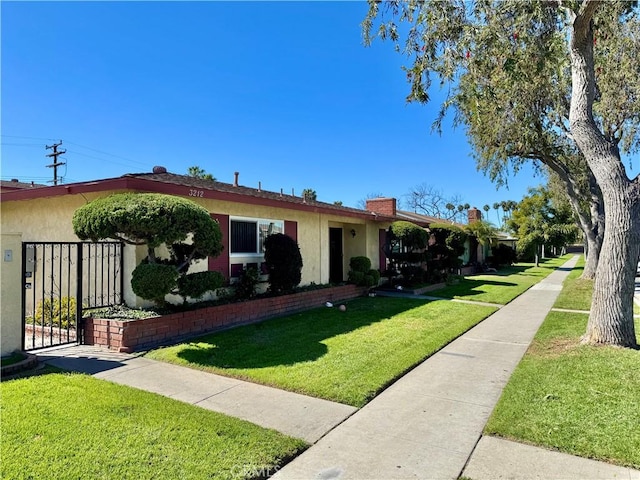 single story home with stucco siding and a front yard