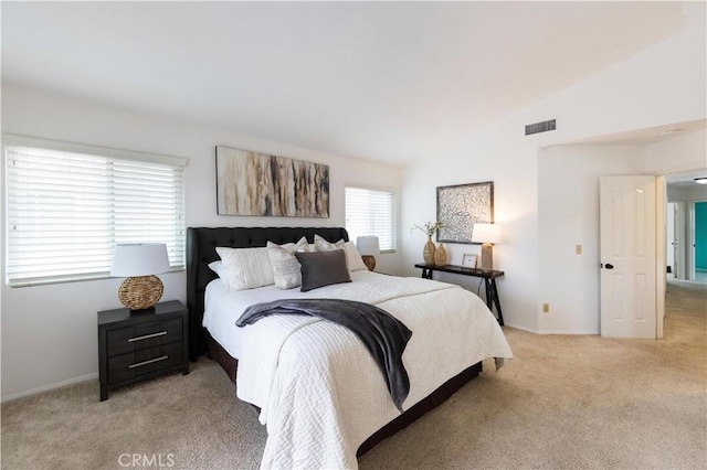 bedroom featuring vaulted ceiling, light colored carpet, visible vents, and baseboards