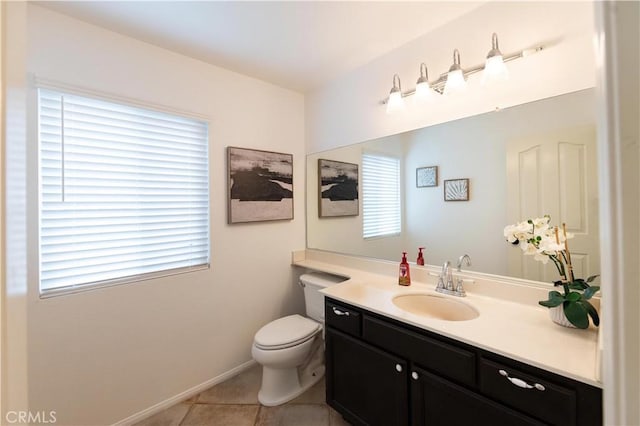 bathroom featuring tile patterned floors, baseboards, toilet, and vanity