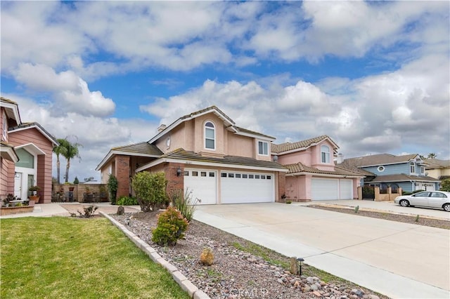 traditional-style home featuring a tile roof, concrete driveway, a garage, and stucco siding