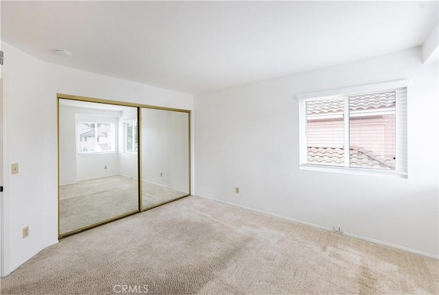 unfurnished bedroom featuring a closet and carpet floors