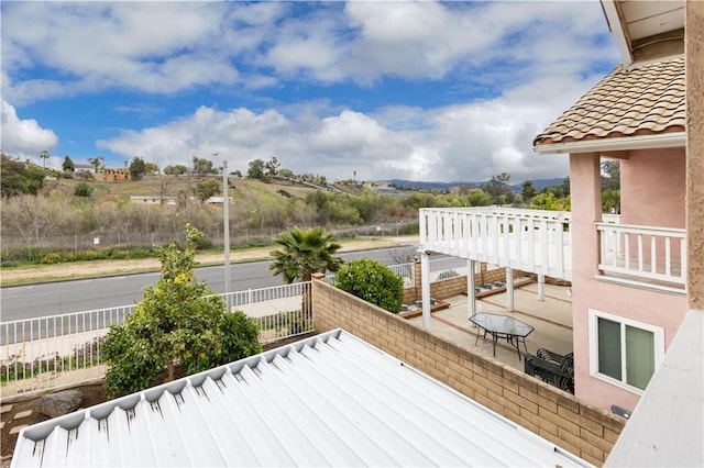 wooden deck with a patio and fence