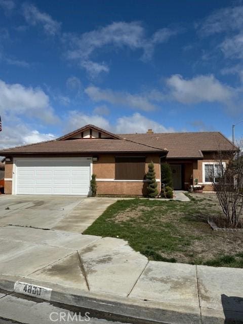 ranch-style home with a garage and driveway