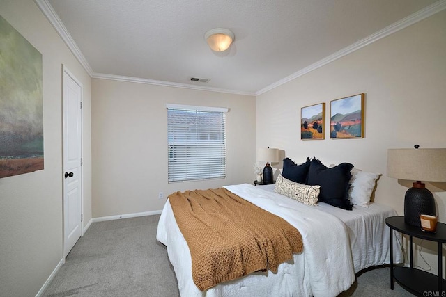 carpeted bedroom with visible vents, baseboards, and crown molding