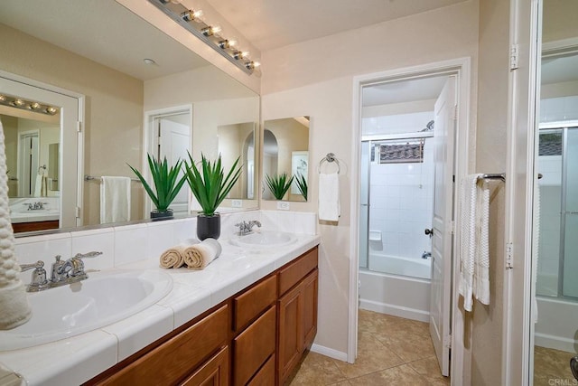 bathroom featuring tile patterned flooring, double vanity, and a sink