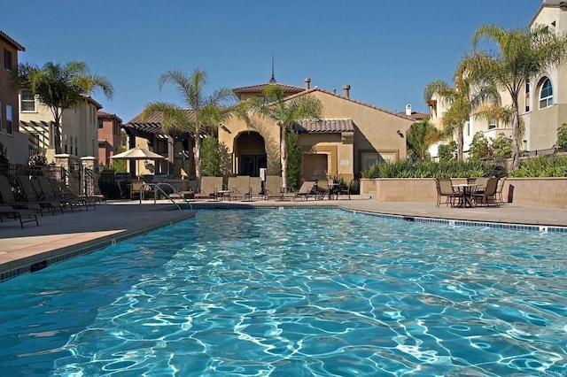 pool featuring a patio area and fence