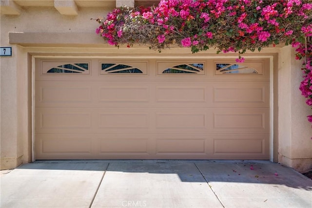 garage featuring concrete driveway