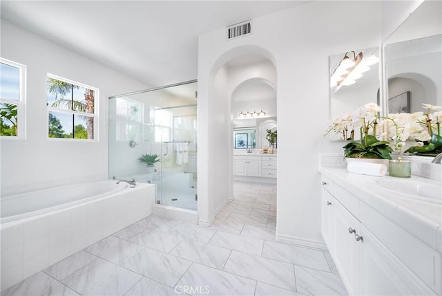 bathroom featuring visible vents, a garden tub, a stall shower, marble finish floor, and a sink