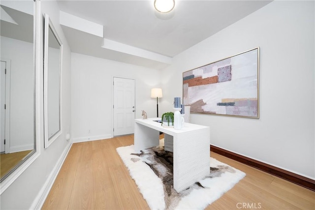 office space featuring baseboards and light wood-style floors