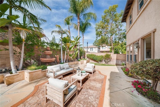 view of patio with an outdoor living space and a fenced backyard