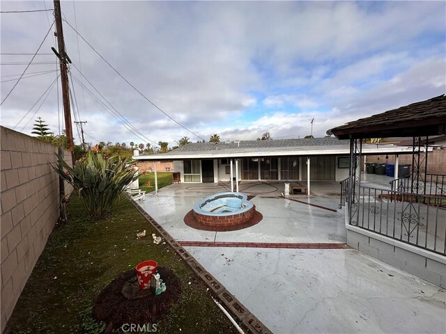 back of house with a patio area, a fenced backyard, and an outdoor fire pit