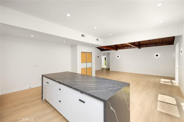 914 N Catalina St, Burbank, CA 91505 - kitchen with beam ceiling, a large island, white cabinets, light wood-type flooring, and recessed lighting
