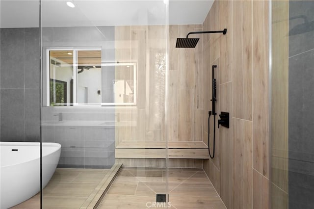 914 N Catalina St, Burbank, CA 91505 - bathroom with a freestanding tub, tile walls, a shower, and tile patterned floors