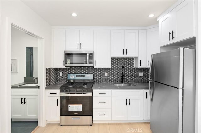914 N Catalina St, Burbank, CA 91505 - kitchen with stainless steel appliances, a sink, dark countertops, and recessed lighting