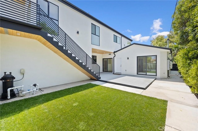 914 N Catalina St, Burbank, CA 91505 - back of property featuring stairs, stucco siding, a patio area, and a yard