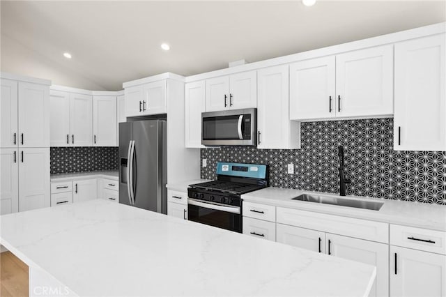 914 N Catalina St, Burbank, CA 91505 - kitchen featuring appliances with stainless steel finishes, a sink, white cabinets, tasteful backsplash, and recessed lighting