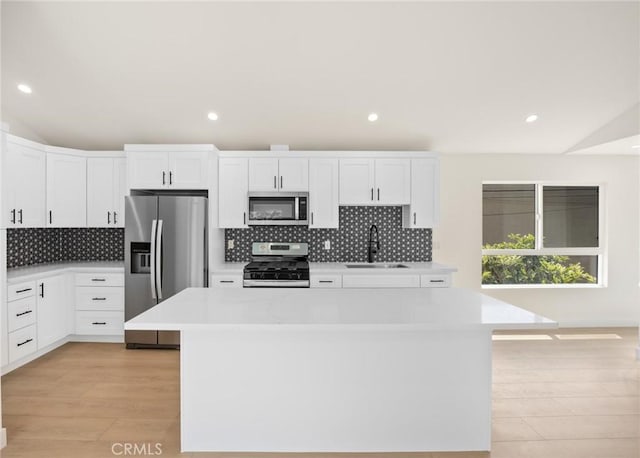 914 N Catalina St, Burbank, CA 91505 - kitchen featuring stainless steel appliances, a sink, light countertops, light wood-style floors, and recessed lighting