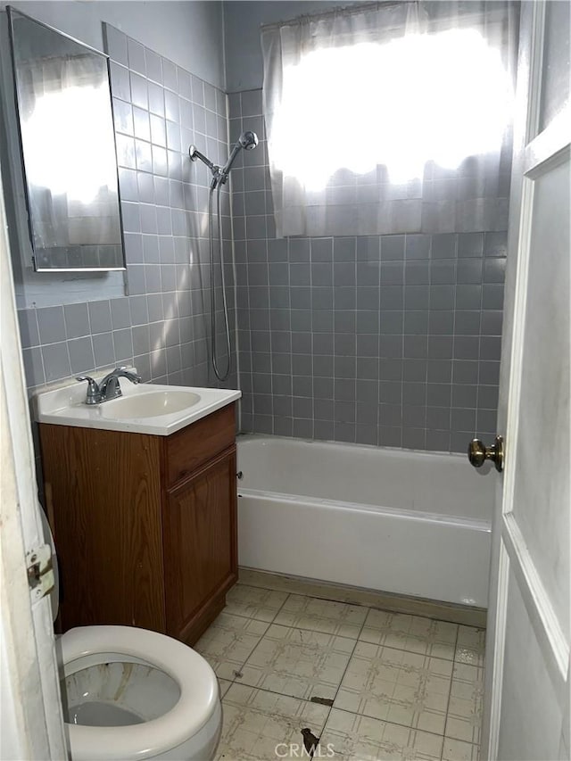 full bath with tile patterned floors, toilet, vanity, and bathtub / shower combination