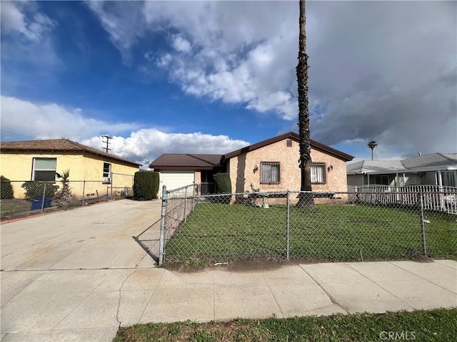 view of front of home with a front lawn, driveway, and a fenced front yard