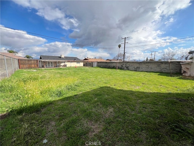 view of yard featuring a fenced backyard