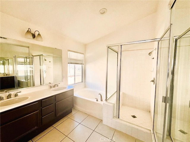 bathroom with a garden tub, tile patterned floors, a shower stall, and a sink