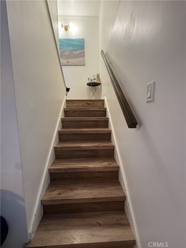 stairs featuring wood finished floors