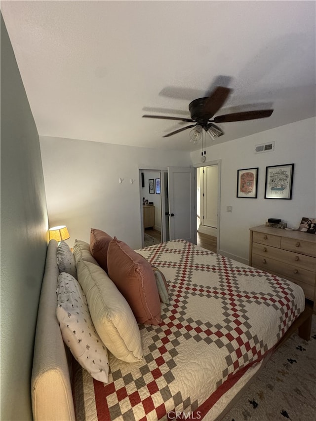 bedroom featuring visible vents, ceiling fan, and carpet floors