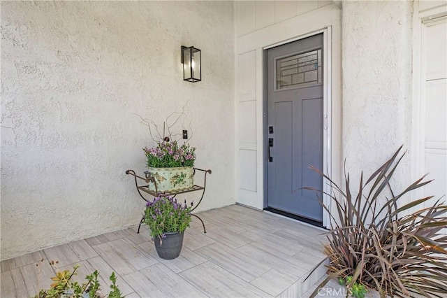 entrance to property with stucco siding