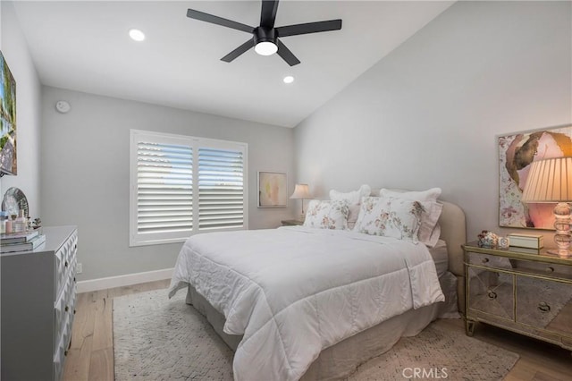 bedroom featuring recessed lighting, baseboards, light wood-style floors, and vaulted ceiling