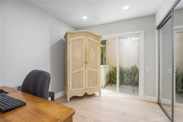 office featuring recessed lighting, light wood-type flooring, and baseboards